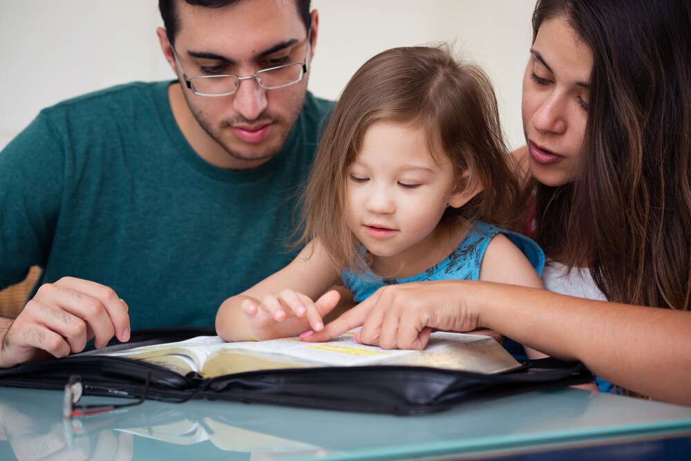 young-family-studying-the-Bible-together