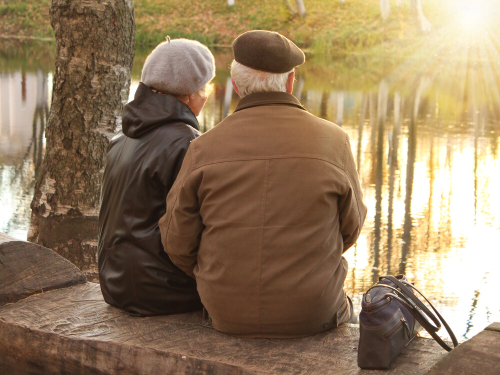 back-view-elderly-couple-sitting-on-bench