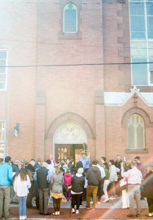 Group outside church door on Palm Sunday