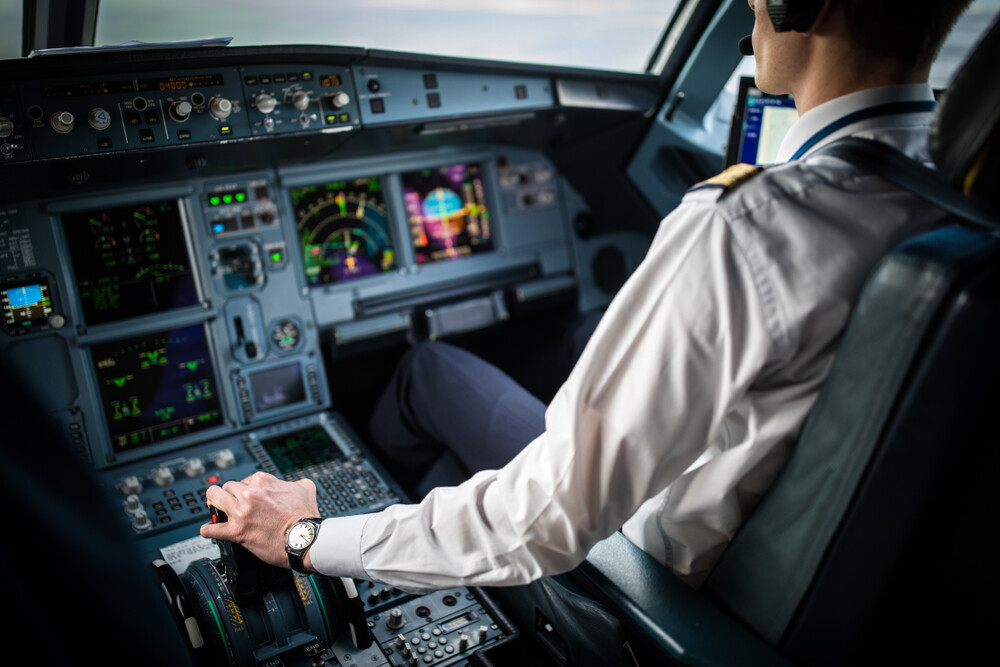 pilot-in-cockpit-with-airplane-controls