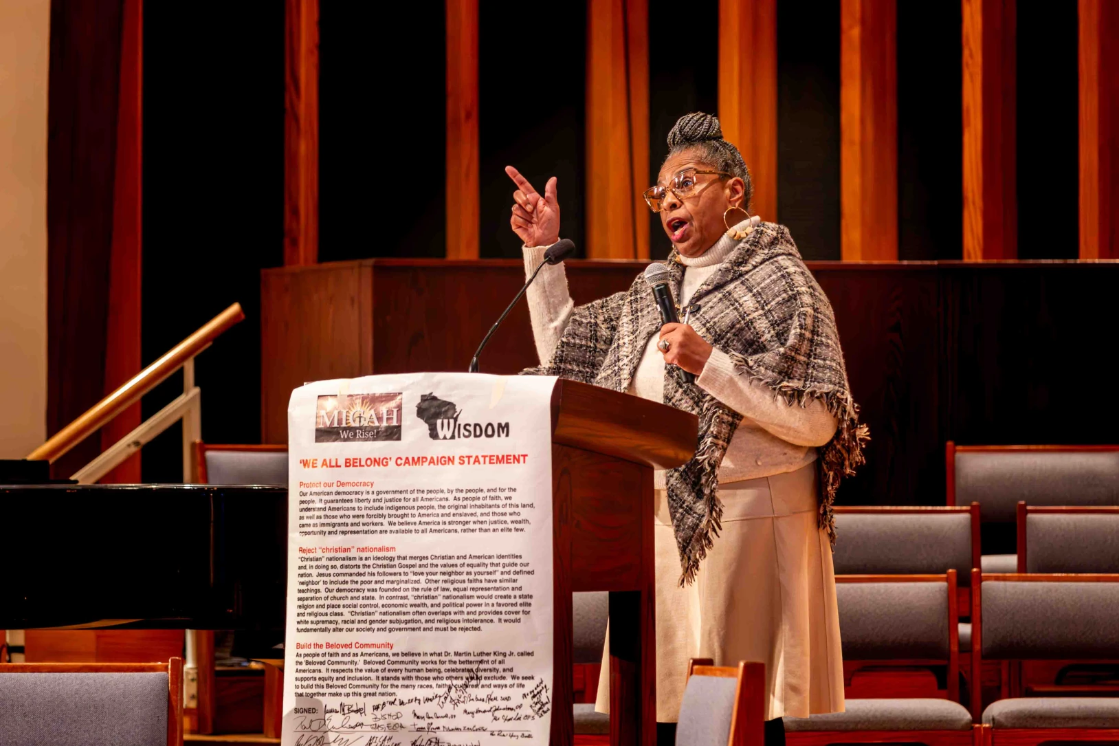 A woman speaks at a social justice event.