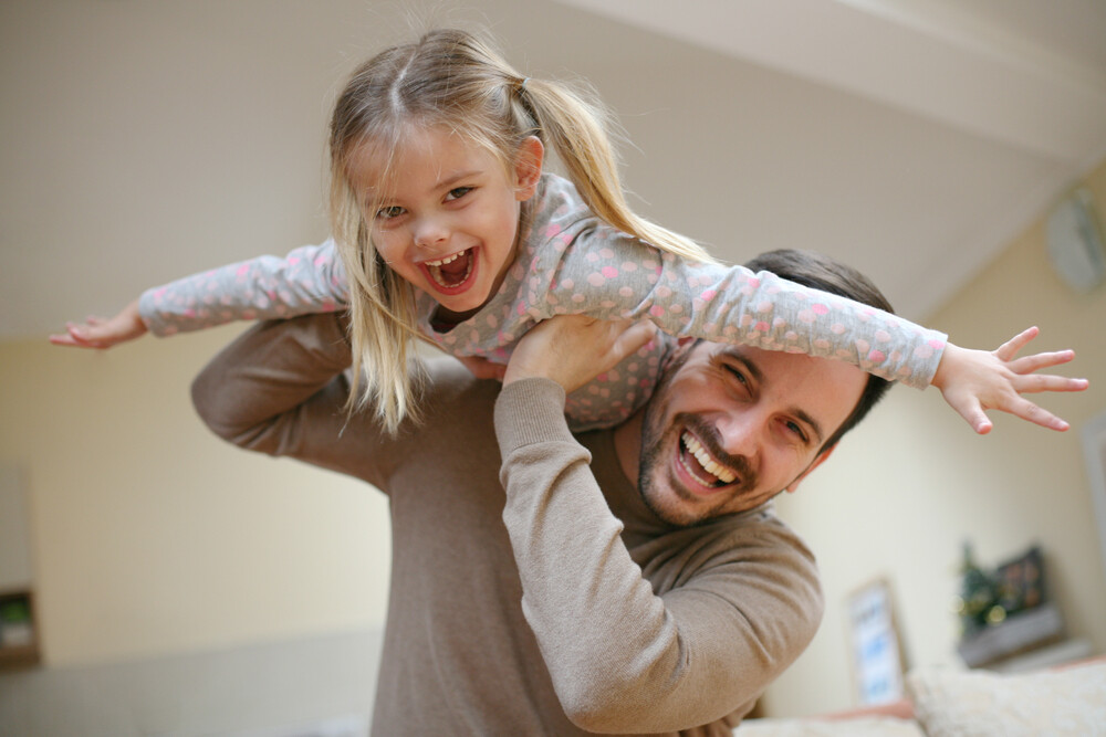happy-young-daughter-piggyback-ride-with-dad