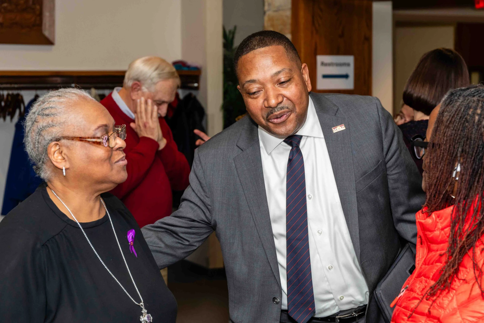 A man and woman talk following a social justice presentation.
