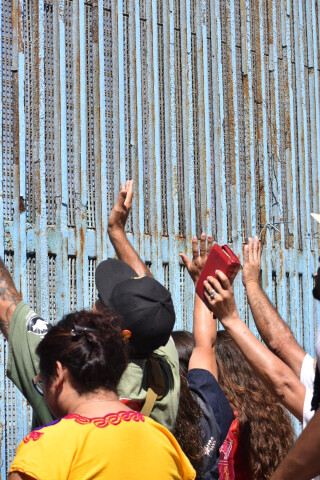 Touching the border wall at friendship park in Tijuana