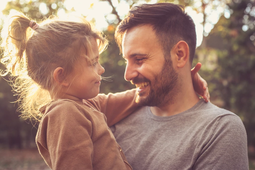 dad-holding-and-smiling-at-his-young-daughter