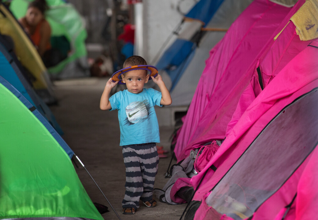 A child of an assylum seeker at a migration shelter full of tents in Tijuana