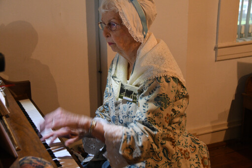 Marian Gottee, the Tour Guide Coordinator at Strawbridge Shrine, plays the piano during the Shrine's annual meeting.