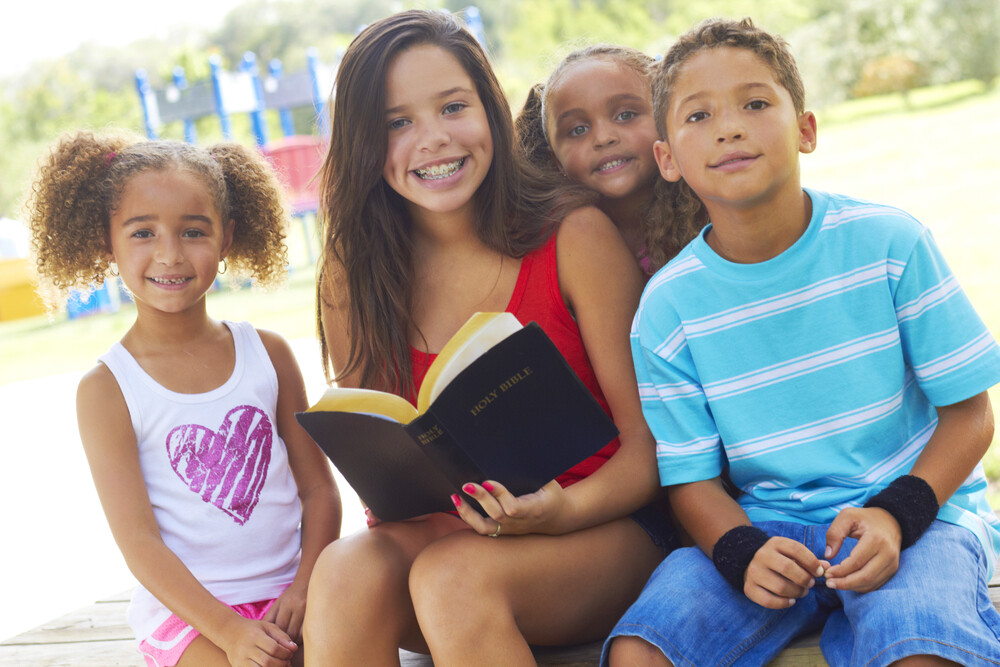 happy-group-of-kids-reading-the-Bible-together