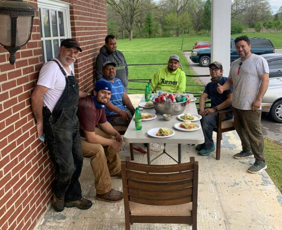 Pastor German and members taking a break from construction work in May 2021
