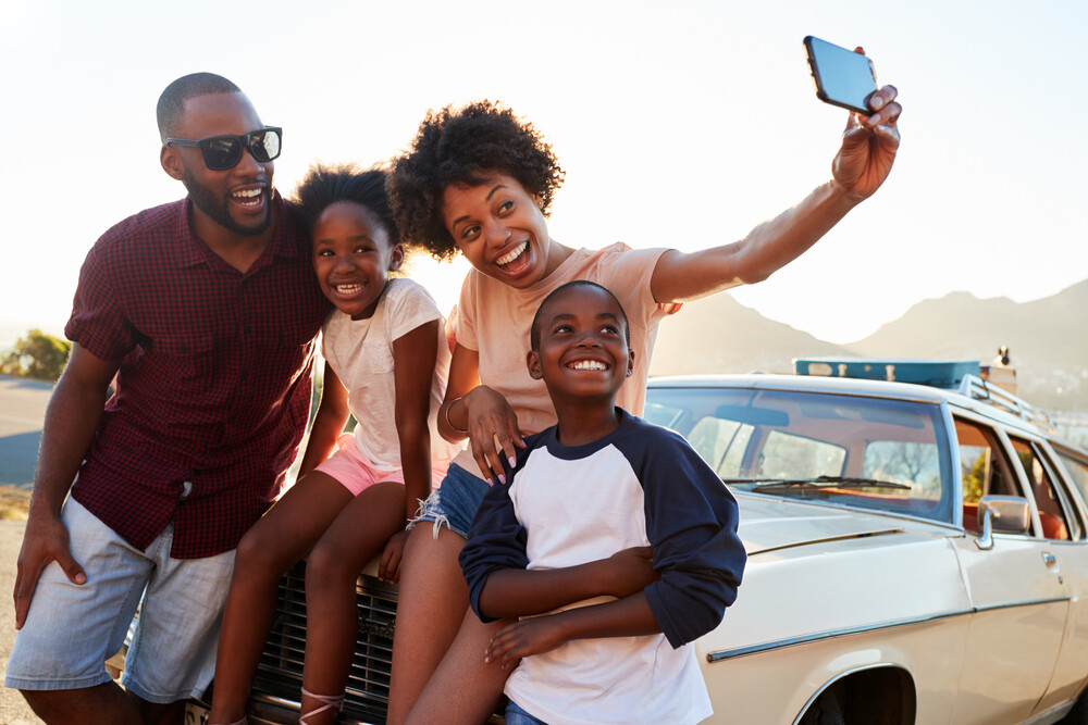 happy-young-family-taking-photos-on-a-road-trip
