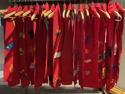 Red stoles hanging in a line. 