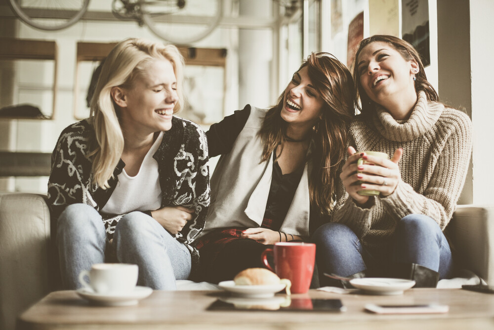 three-happy-female-friends-connecting-over-coffee