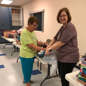 Sewing Circle Members filling bags with donations