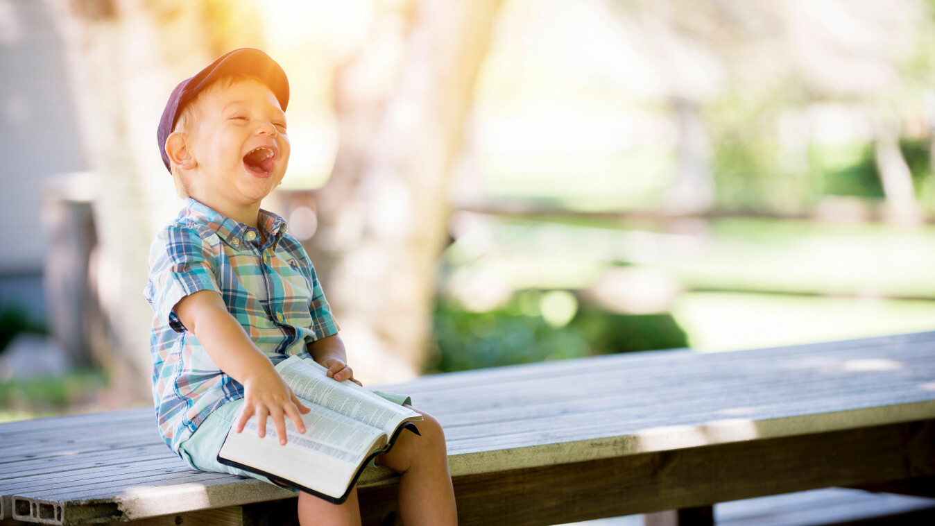 happy child reading Bible