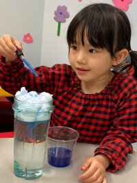 Girl doing science experiment.