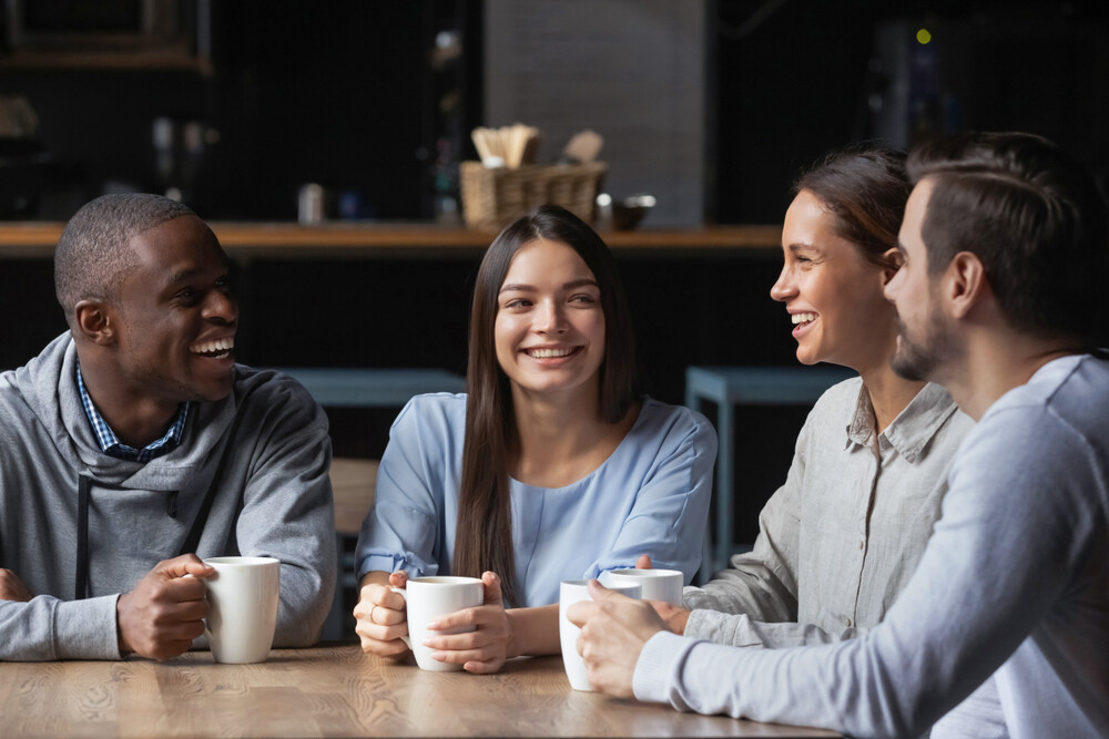 group-of-young-adults-drinking-coffee-and-chatting