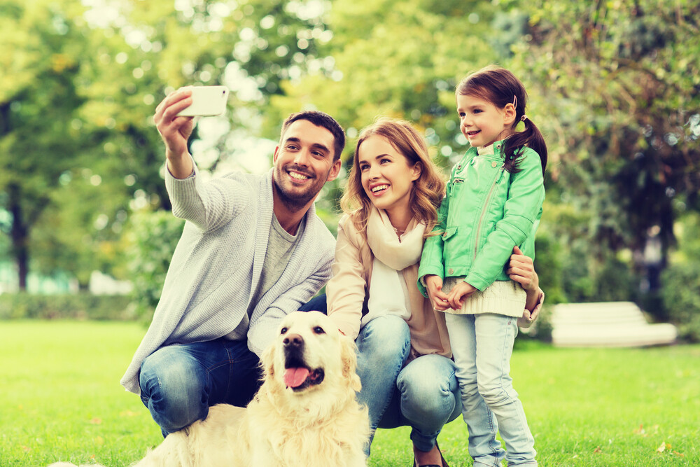 happy-young-family-taking-a-family-selfie-outdoors