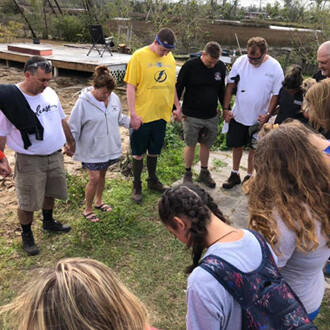 students praying on mission trip