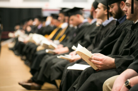 Students seated at graduation. 