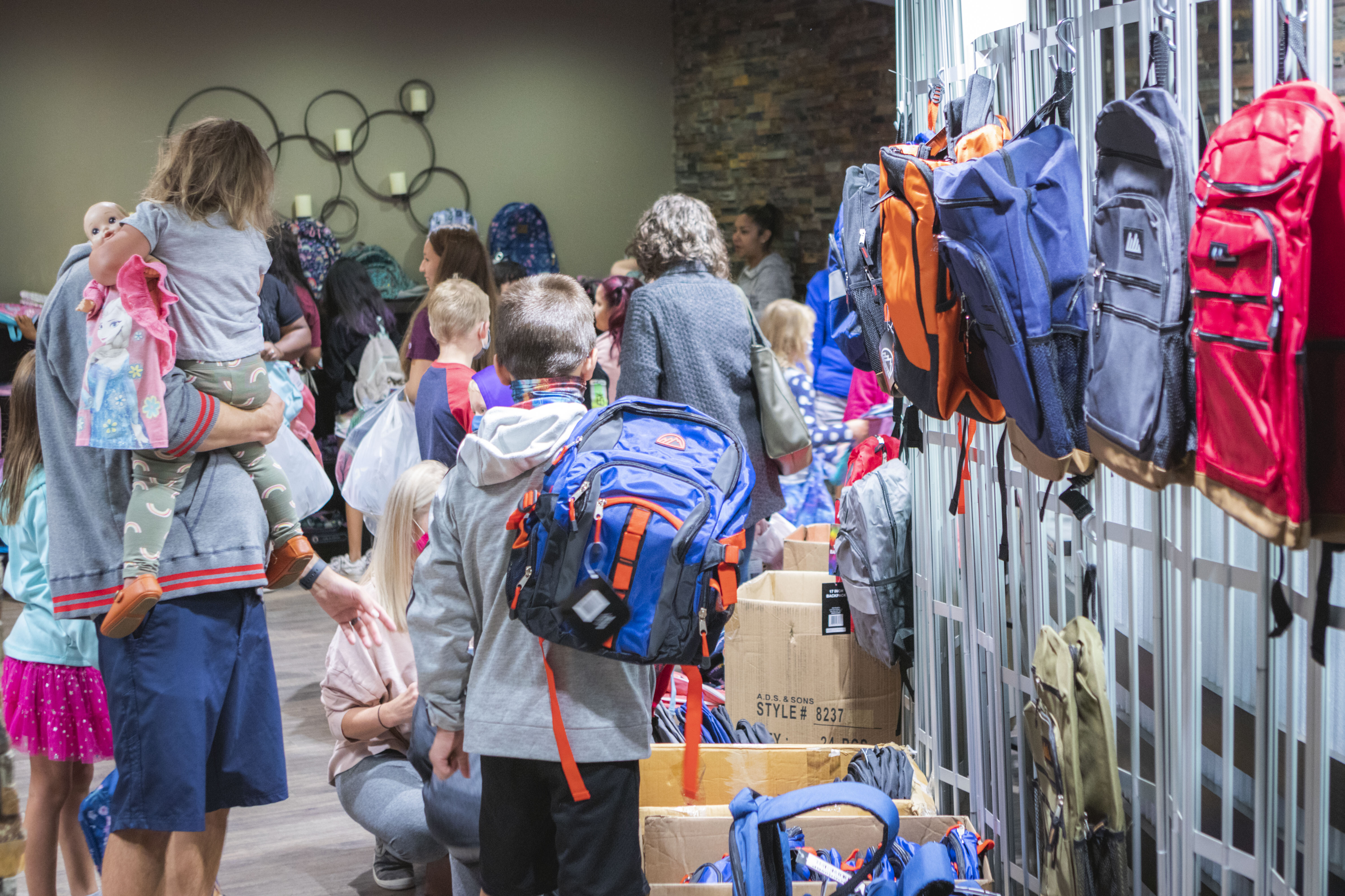 families-shopping-for-backpacks-at-school-a-palooza