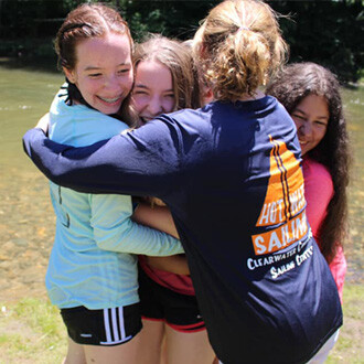 students hugging at camp