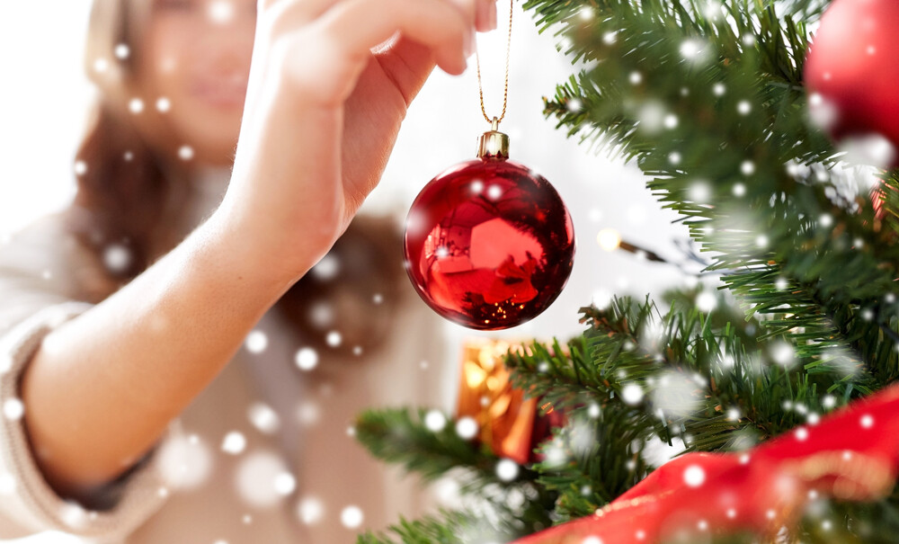 close-up-of-young-women-decorating-the-Christmas-tree