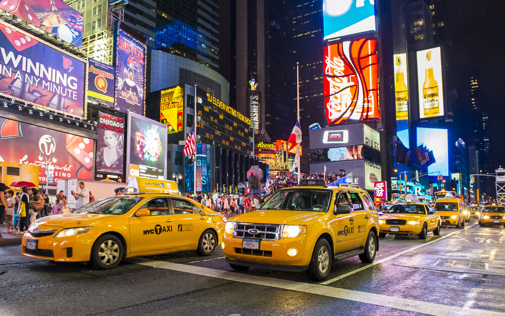 taxis-and-people-on-busy-New-York-City-street-at-night
