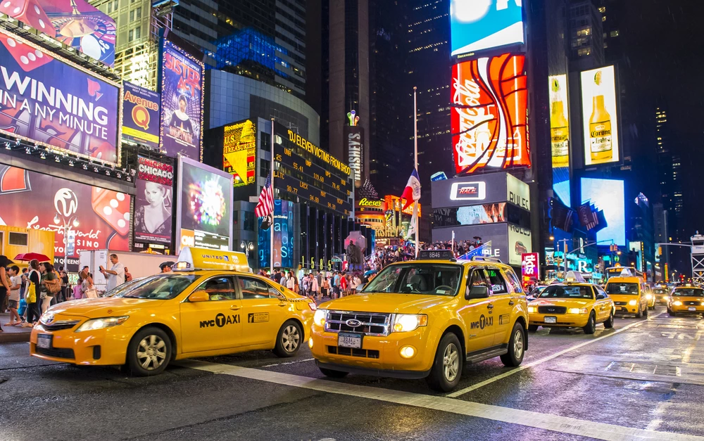 taxis-and-people-on-busy-New-York-City-street-at-night