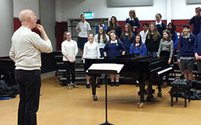 Don instructs a chorus at Tawa College in New Zealand