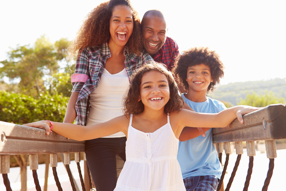 young-family-having-fun-on-a-playground-on-a-summer-day