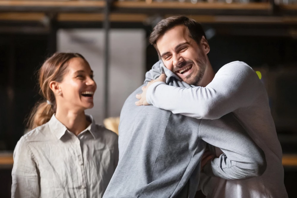 two-buddies-giving-friendly-hug-happy-to-see-one-another