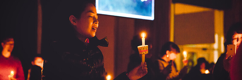 Woman sings Silent Night during Capital Community Church's candlelight service in Beijing, China