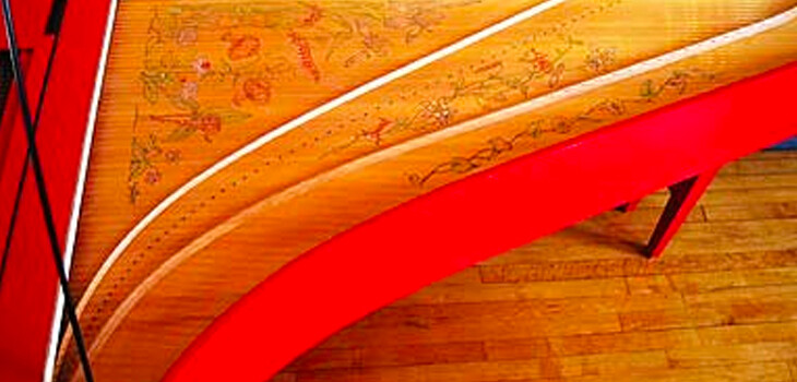 Detail of floral artwork inside a red harpsichord