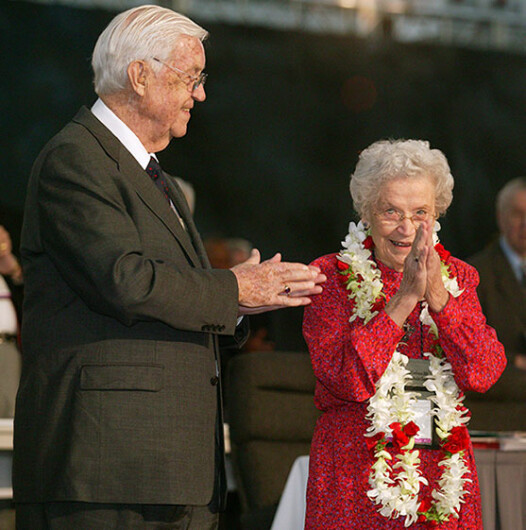 Eunice Mathews acknowledges applause from delegates and guests as the United Methodist Church’s 2004 General Conference in Pittsburgh celebrates her lifetime of service to the church. The conference honored Mathews on her 90th birthday. Joining the tribute is her husband, Bishop James K. Mathews. Photo by Mike DuBose.