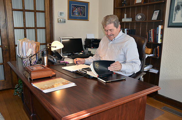 The Rev. David Simpson works at his desk in the office of Calvary UMC in Frederick.