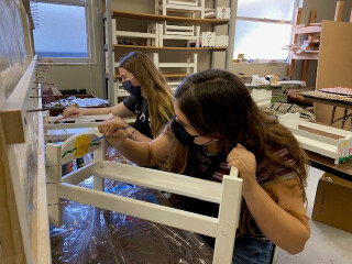Students painting doll bed