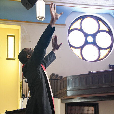 Pastor Bresean Jenkins prays at Ebenezer UMC.