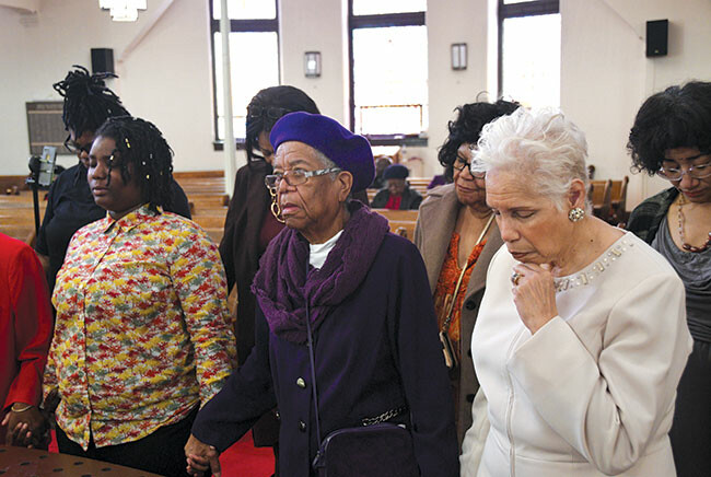 Members of Ebenezer UMC gather at the altar for prayer on Founder’s Day.