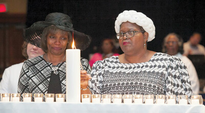 Friends and family of those who died during the previous year light candles for their loved ones during the Memorial Service June 2.