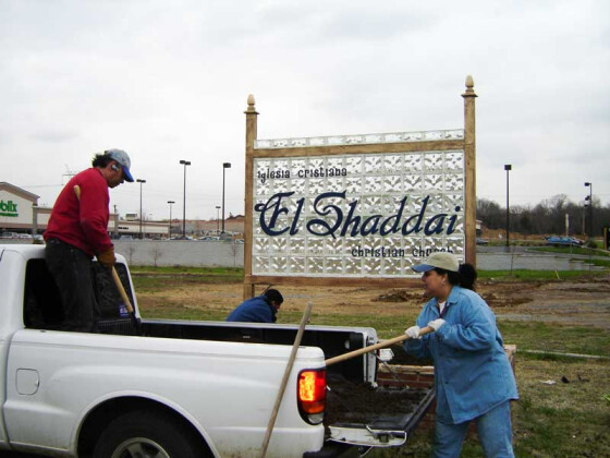 Pastor German and Margaret installing the church sign in 2005