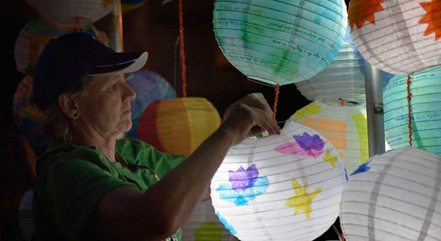 The Rev. Cindy Roberts disassembles lanterns following a May 12 climate vigil outside the 2016 United Methodist General Conference in Portland, Ore. The lanterns were lit with a small solar light that following the vigil were sent to community groups in the Philippines, the Democratic Republic of the Congo, and the United States. Donohew is pastor of Brownsville UMC in the U.S. state of Washington. Photo by Paul Jeffrey, UMNS.