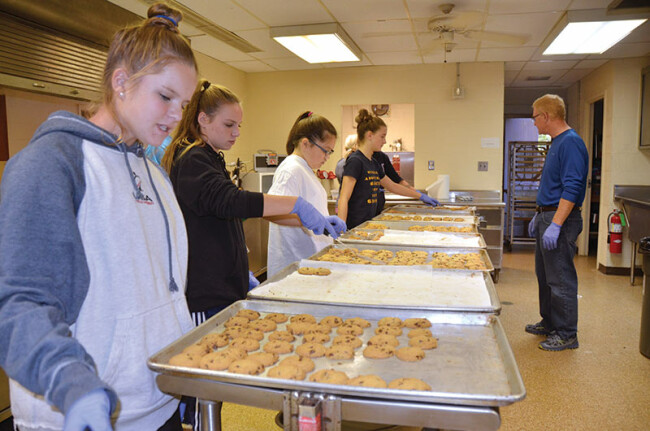 Members of all ages at Calvary UMC in Annapolis make 827 dozen cookies. The monthly Cookie Factory raises funds for mission trips.
