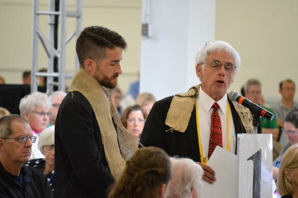 The Revs. Will Green (left) and John Blackadar offer a resolution that the New England Conference of The United Methodist Church "will not conform or comply with provisions of the Discipline which discriminate against LGBTQIA persons," during the conference meeting in Manchester, N.H. Photo by Beth DiCocco, New England Conference.