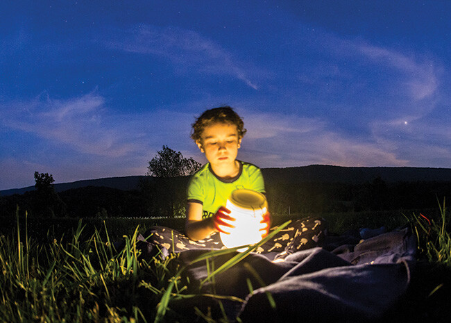 A camper at Manidoken reflects on nature at summer camp. Camping opportunities are provided at three facilities throughout the BWC.