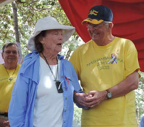 Claire Burrill, 90, and Charlie Moore help celebrate the dedication of new classrooms. Photo by Eveline Chikwanah.