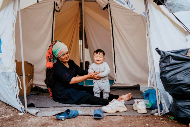 Refugee woman and her child in the camp