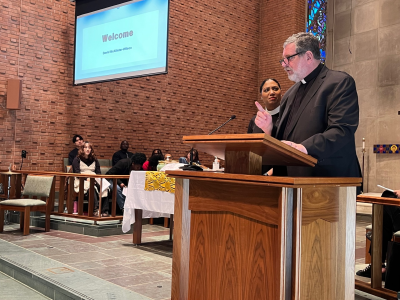 The Rev. David McAllister-Wilson welcomes people to the United to Love Prayer service.&nbsp;