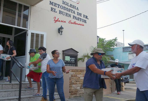 A group of members and pastors from Methodist churches in the San Juan area form a human chain to unload supplies at the Utuado church in central Puerto Rico. The "brigade" drove into the area to help meet the needs of people who have not been reached by FEMA or federal aid organizations. Photo by the Rev. Gustavo Vasquez, UMNS.