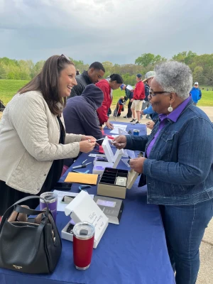 Cheryl Cook, left, helps Bishop LaTrelle Easterling at the start of the Seeds of Security Golf Tournament.&nbsp;