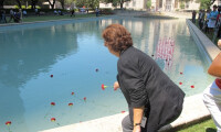 Debra M. Klinger, Human Resources Administrator, placing a flower in the Reflection Pool